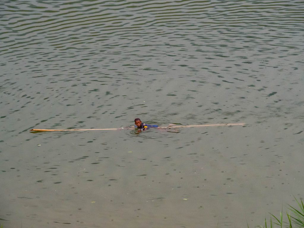 Boy swimming in Nam Ou river