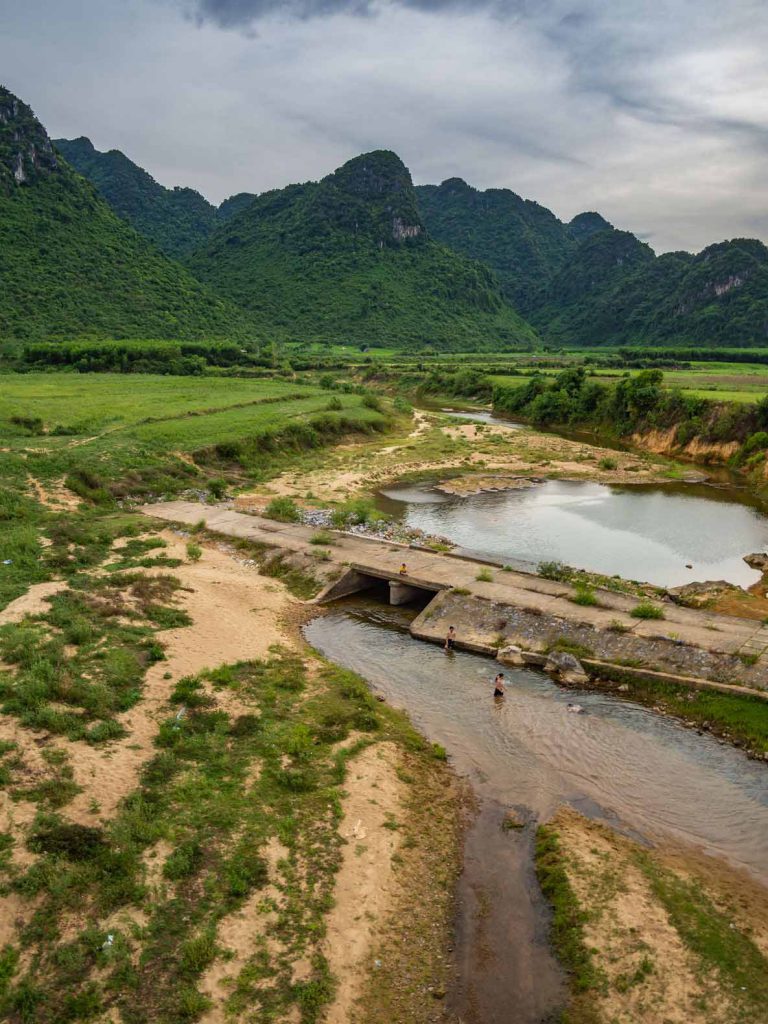 Children playing in the river at Phong Nha