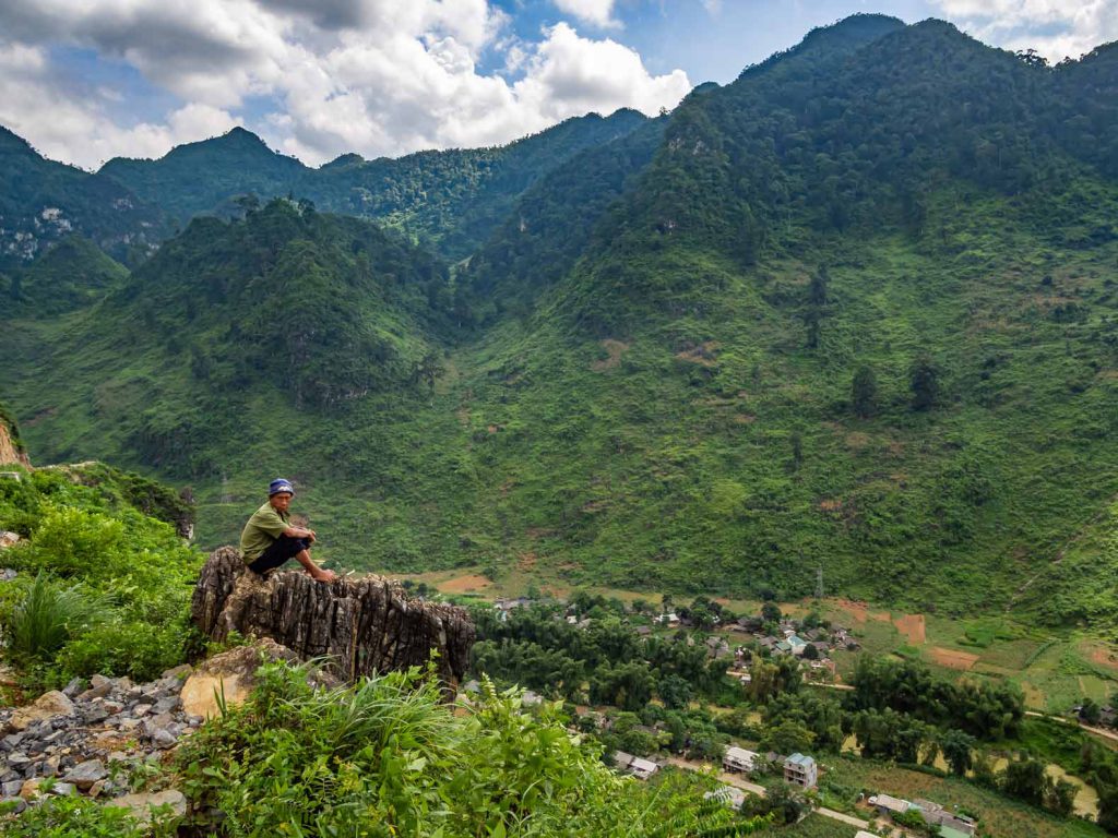 A Vietnamese local overlooking the valley and the Son Lo river in Northern Vietnam