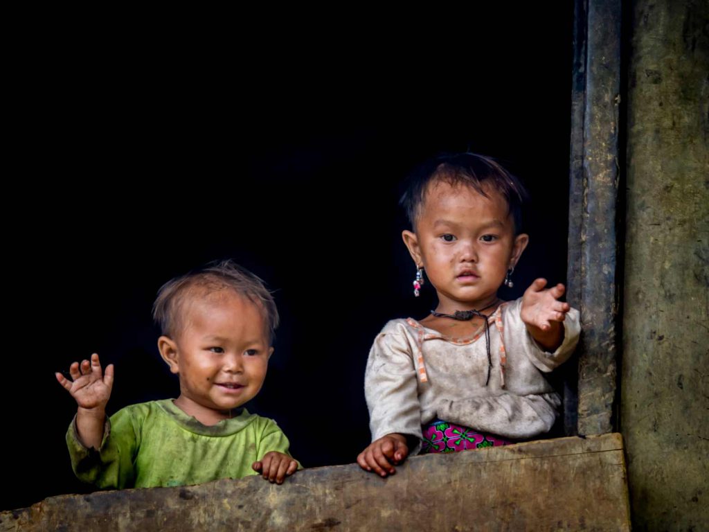 Vietnamese children waving at the camera