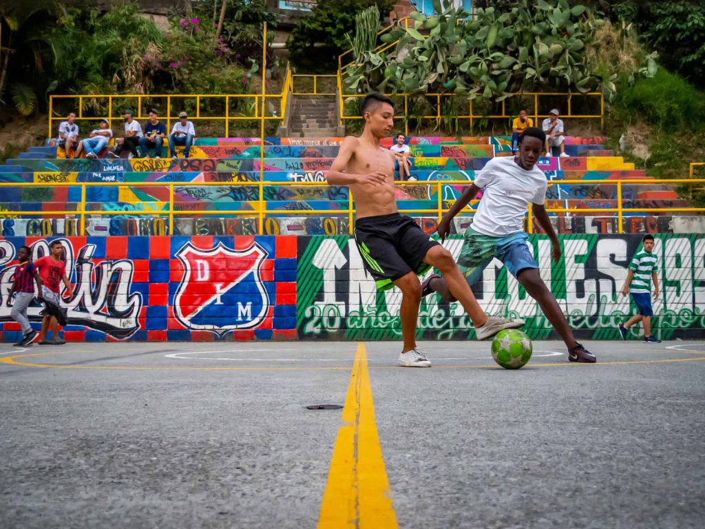 Teenagers playing soccer on a soccer field in Comuna 13 in Medellin, Colombia